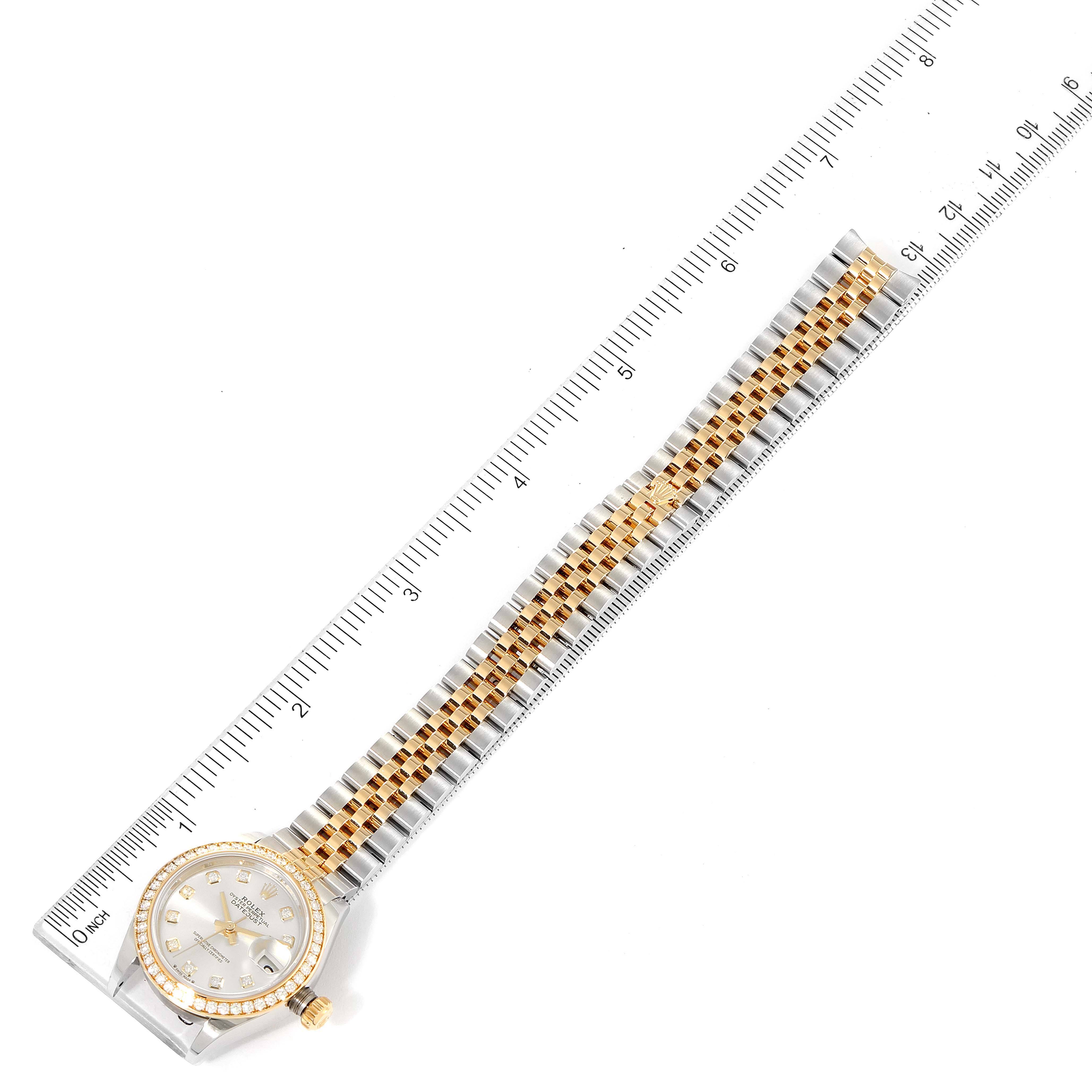 This image shows a top view of a Rolex Datejust 279383 Women
s Steel and Gold (two tone) Silver Dial 279383 Women
s Steel and Gold (two tone) Silver Dial watch, displaying the face, bezel, and full bracelet with rulers for scale.