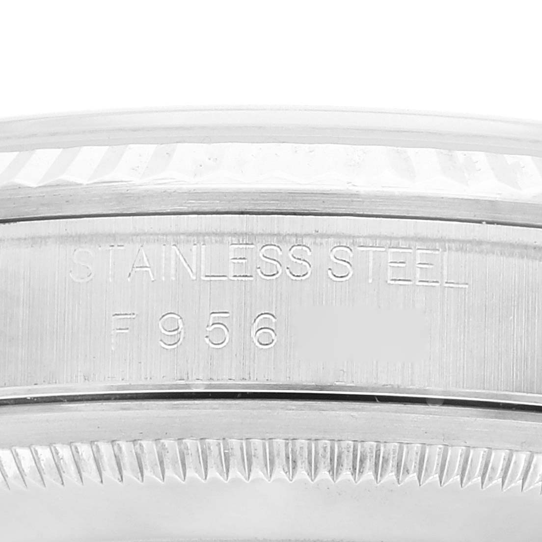This image shows a close-up view of the stainless steel case back and fluted bezel of a Rolex Datejust 16234 Men's Stainless Steel Silver Dial 16234 Men's Stainless Steel Silver Dial watch, engraved with serial details.