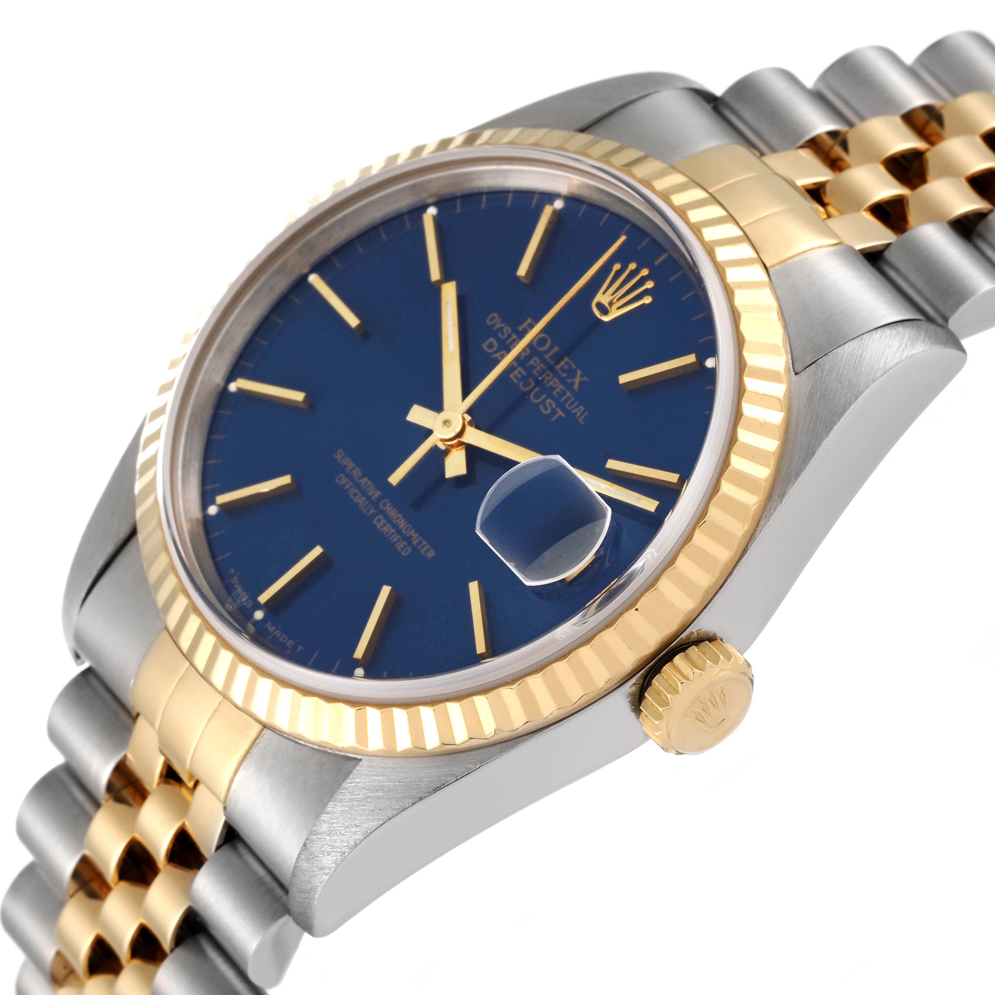 This image shows a Rolex Datejust 16233 Men's Steel and Gold (two tone) Black Dial 16233 Men's Steel and Gold (two tone) Black Dial watch from an angled side view, highlighting the blue dial, date window, gold bezel, and two-tone bracelet.