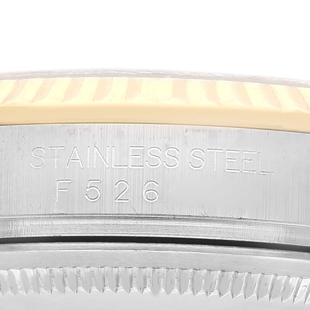 Close-up of the stainless steel engraved bezel case on a Rolex Datejust 116233 Men's Steel and Gold (two tone) Champagne Dial 116233 Men's Steel and Gold (two tone) Champagne Dial watch.