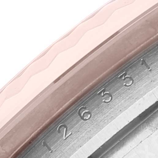 This close-up shows part of the bezel and the inner rim with serial numbers of the Rolex Datejust 41 126331 Men
s Steel and Gold (two tone) Brown Dial 126331 Men
s Steel and Gold (two tone) Brown Dial model.