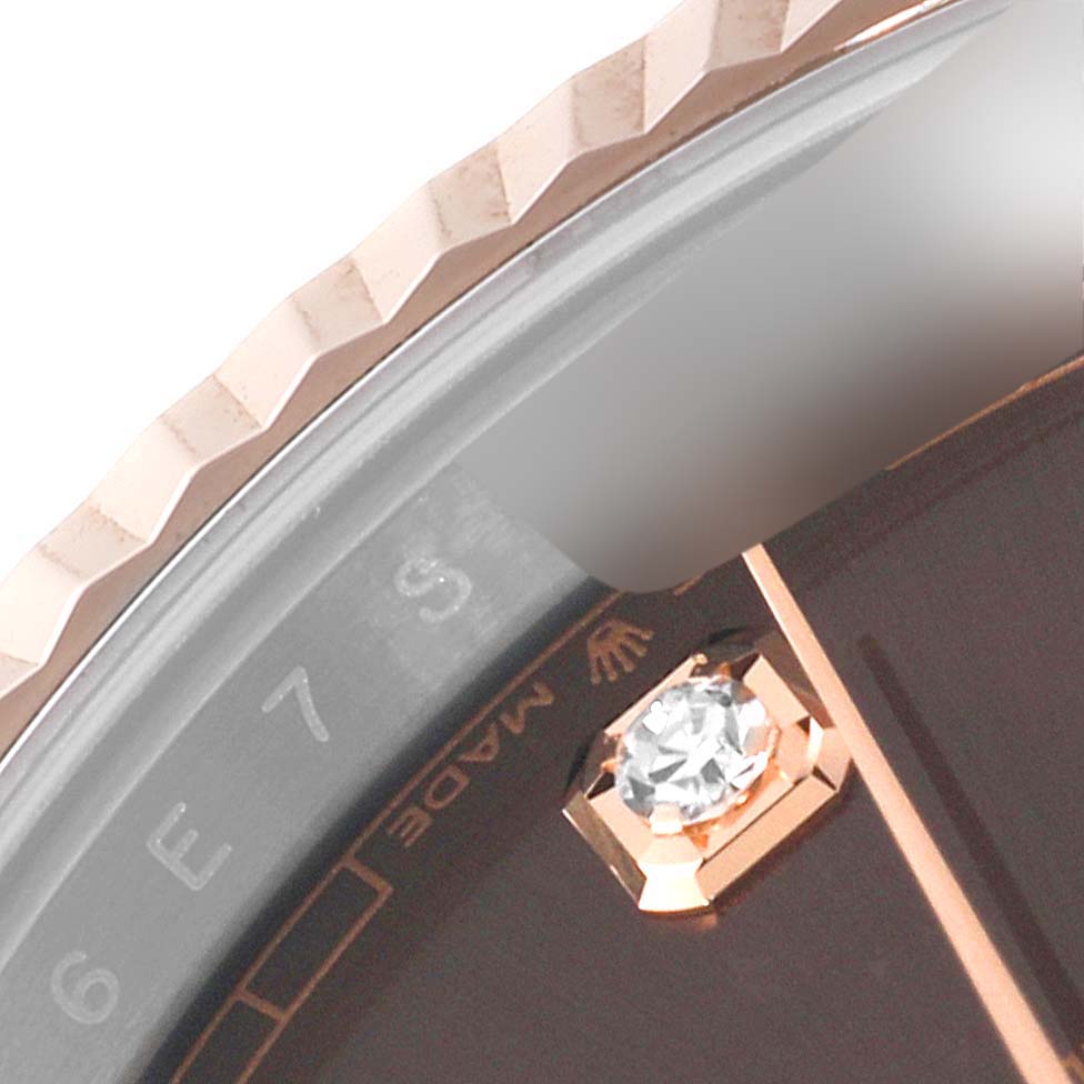 This close-up image of the Rolex Datejust 41 126331 Men
s Steel and Gold (two tone) Brown Dial 126331 Men
s Steel and Gold (two tone) Brown Dial shows the fluted bezel, part of the dial with a diamond hour marker, and 
Made
 text.