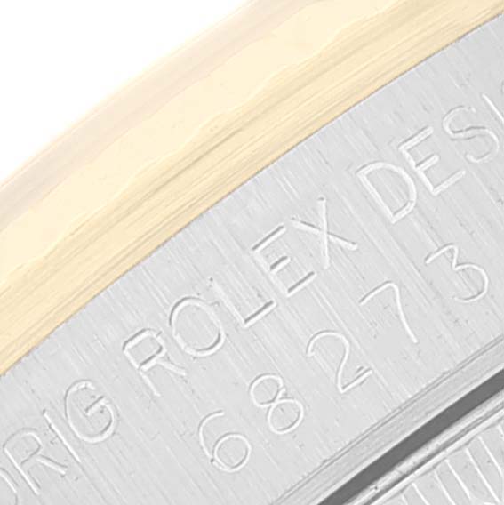 The close-up image shows the engraved details on the case back of a Mid-Size Rolex watch.