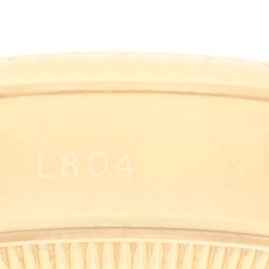 This image shows a close-up view of the serial number engraved on the bezel of a Rolex President 69178 Women
s Yellow Gold Champagne Dial 69178 Women
s Yellow Gold Champagne Dial model watch.