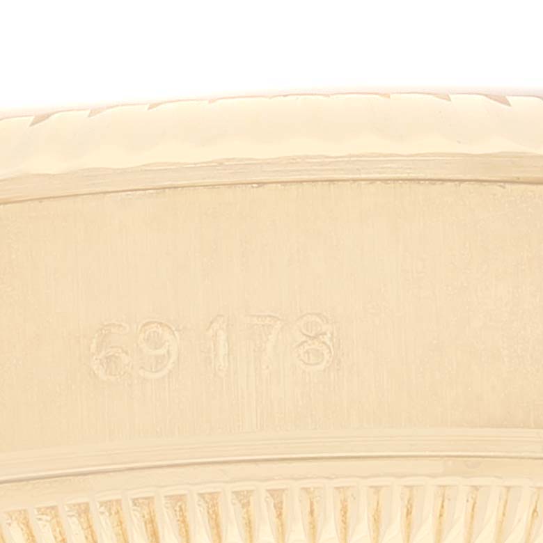 The close-up image shows part of the bezel and the case of the Rolex President 69178 Women
s Yellow Gold Champagne Dial 69178 Women
s Yellow Gold Champagne Dial model watch with the number "69178" engraved.