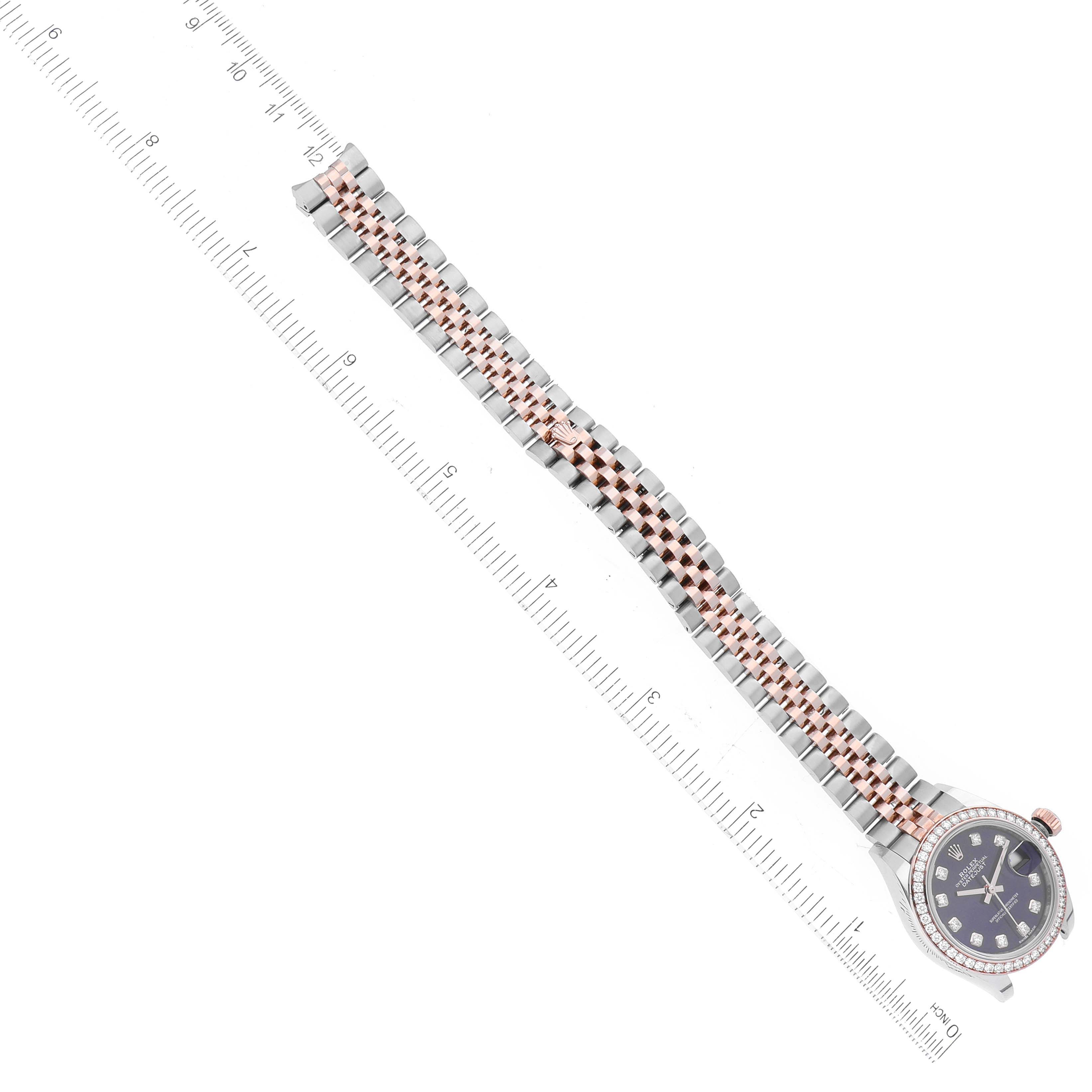 The image shows a Rolex Datejust 279381 Women's Stainless Steel Purple Dial 279381 Women's Stainless Steel Purple Dial watch laid flat next to a ruler, highlighting the bracelet and dial.