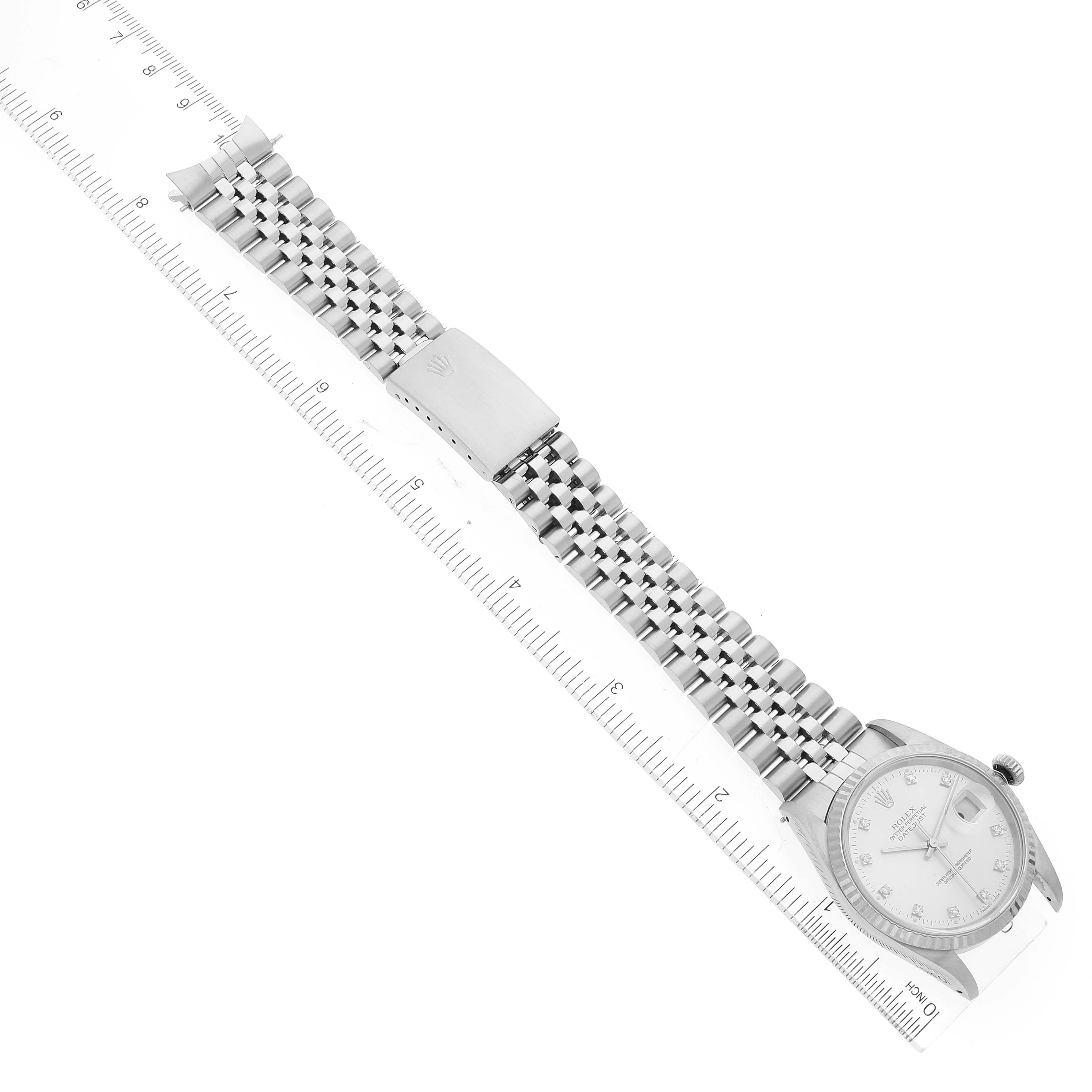 The Rolex Datejust 16234 Men's Stainless Steel Silver Dial 16234 Men's Stainless Steel Silver Dial watch is shown in a top-down view, featuring its bracelet, clasp, and dial over a ruler for scaling.