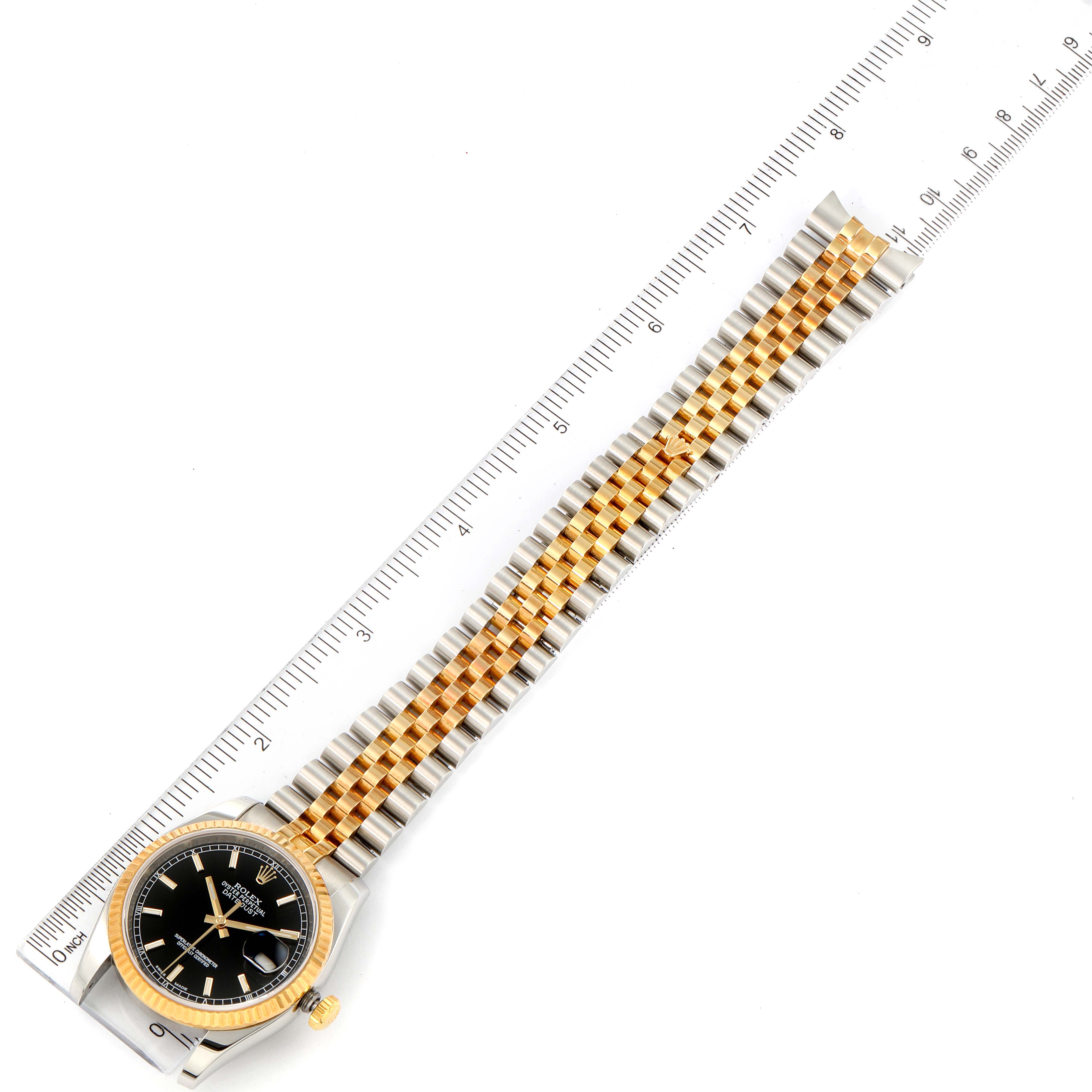 The image shows a Rolex Datejust 116233 Men's Steel and Gold (two tone) Black Dial 116233 Men's Steel and Gold (two tone) Black Dial watch from an overhead angle, displaying the entire watch, including the two-tone bracelet, case, and dial.