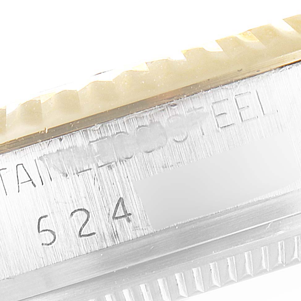 The image shows a close-up of the side of a Vintage Collection Rolex watch, highlighting the stainless steel material and part of the bezel and serial number.