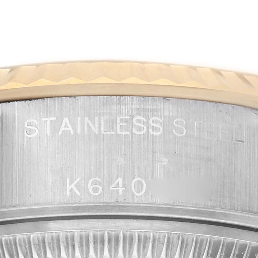 This image shows a close-up view of the stainless steel case and gold bezel of a Rolex Datejust 79173 Women's Steel and Gold (two tone) Champagne Dial 79173 Women's Steel and Gold (two tone) Champagne Dial model watch, highlighting the serial number engraved.