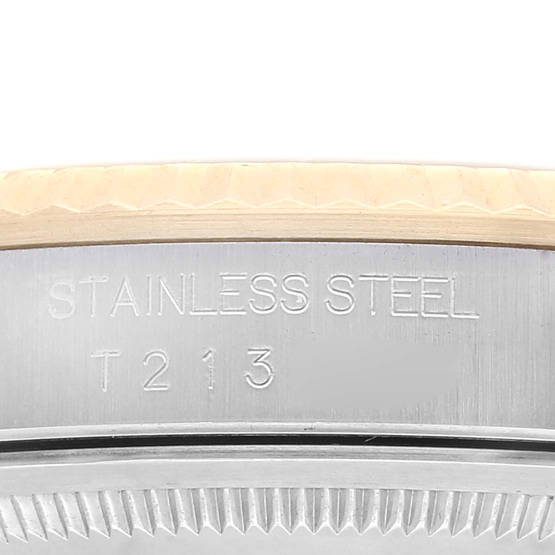 This image shows a close-up of the side of a stainless steel Rolex Datejust 16233 Men's Steel and Gold (two tone) Champagne Dial 16233 Men's Steel and Gold (two tone) Champagne Dial watch with engraved text.