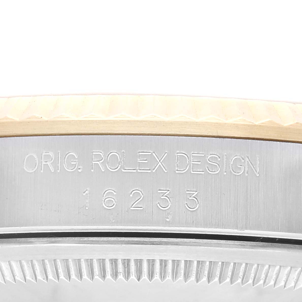 This close-up image shows the side engraving of the case of a Rolex Datejust 16233 Men's Steel and Gold (two tone) Champagne Dial 16233 Men's Steel and Gold (two tone) Champagne Dial model, revealing its model number, 16233.