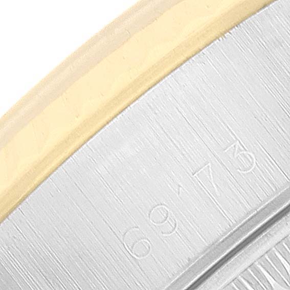 This close-up image shows the side of a Rolex Datejust 69173 Women's Steel and Gold (two tone) Champagne Dial 69173 Women's Steel and Gold (two tone) Champagne Dial watch bezel, highlighting the br?ushed metallic finish and partial engraved numbers.