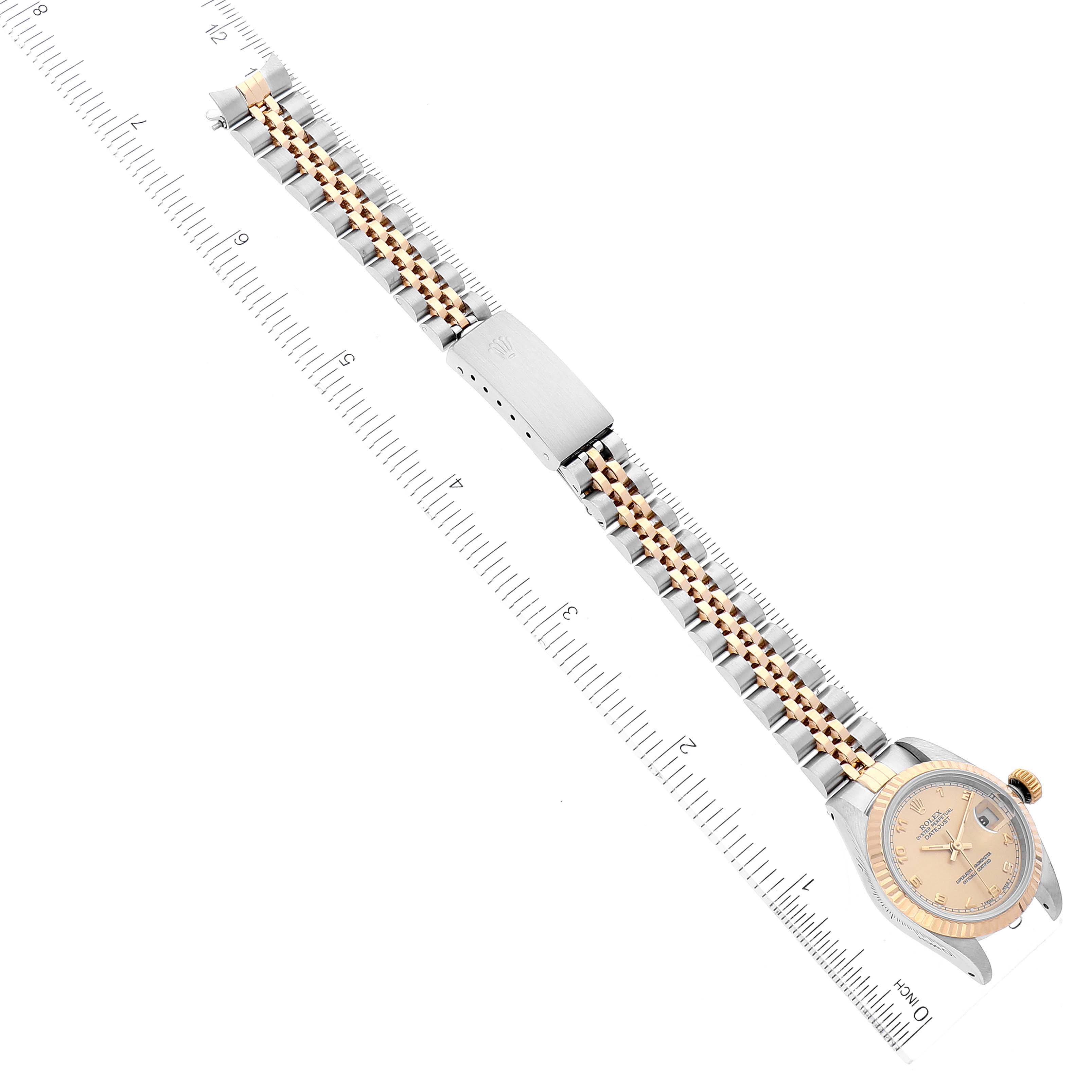 The image shows a Rolex Datejust 69173 Women's Steel and Gold (two tone) Champagne Dial 69173 Women's Steel and Gold (two tone) Champagne Dial watch laid flat on a ruler, showcasing the dial, case, and two-tone bracelet from an overhead angle.