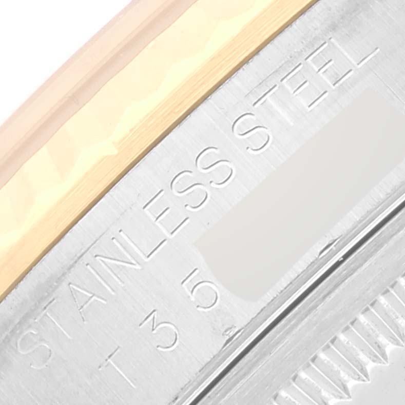 This image shows a close-up of the engraved identification markings on the side of a Rolex Datejust 16233 Men's Steel and Gold (two tone) Beige Dial 16233 Men's Steel and Gold (two tone) Beige Dial watch, focusing on the stainless steel text.