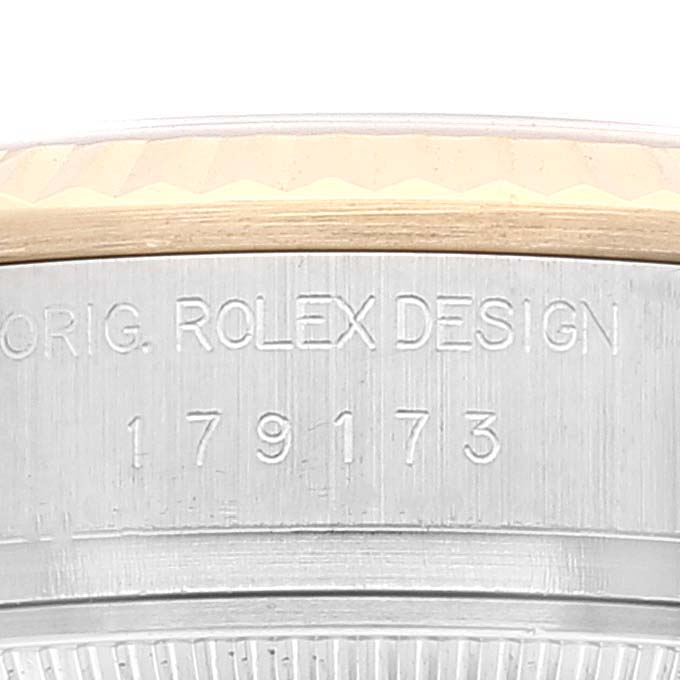 Close-up of the side of a Rolex Datejust 179173 Women's Stainless Steel White Dial 179173 Women's Stainless Steel White Dial watch, showing "ORIG. ROLEX DESIGN" and the model number engraved.