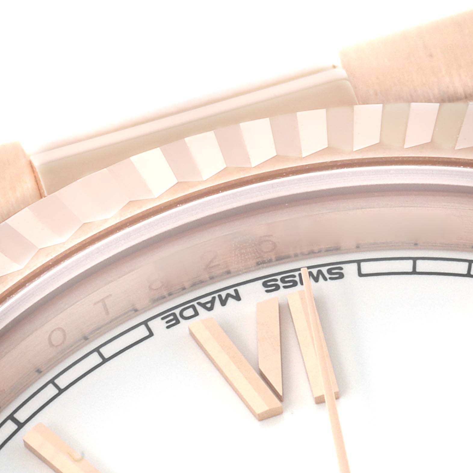 The image shows a close-up side angle of the Rolex President 228235 Men's Rose Gold White Dial 228235 Men's Rose Gold White Dial watch, highlighting the bezel, part of the face, and minute markers.