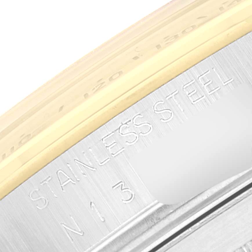 Close-up of the side case and bezel edge of a Rolex Daytona 16523 Men's Steel and Gold (two tone) Black Dial 16523 Men's Steel and Gold (two tone) Black Dial watch, showing the "STAINLESS STEEL" engraving.