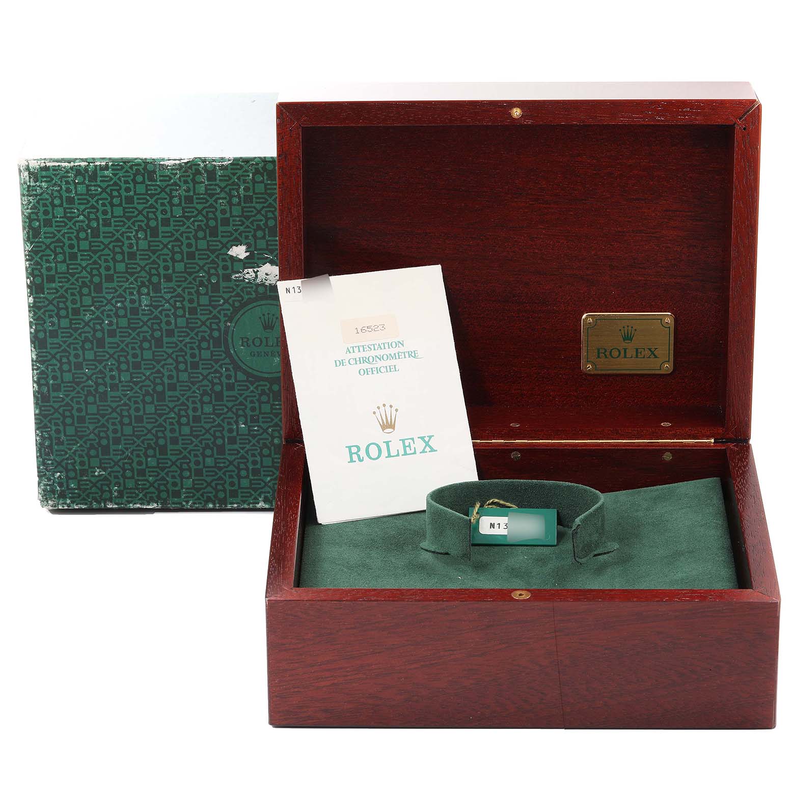 The image shows a Rolex Daytona 16523 Men's Steel and Gold (two tone) Black Dial 16523 Men's Steel and Gold (two tone) Black Dial watch box and certificate, with a green tag, inside a wooden container.