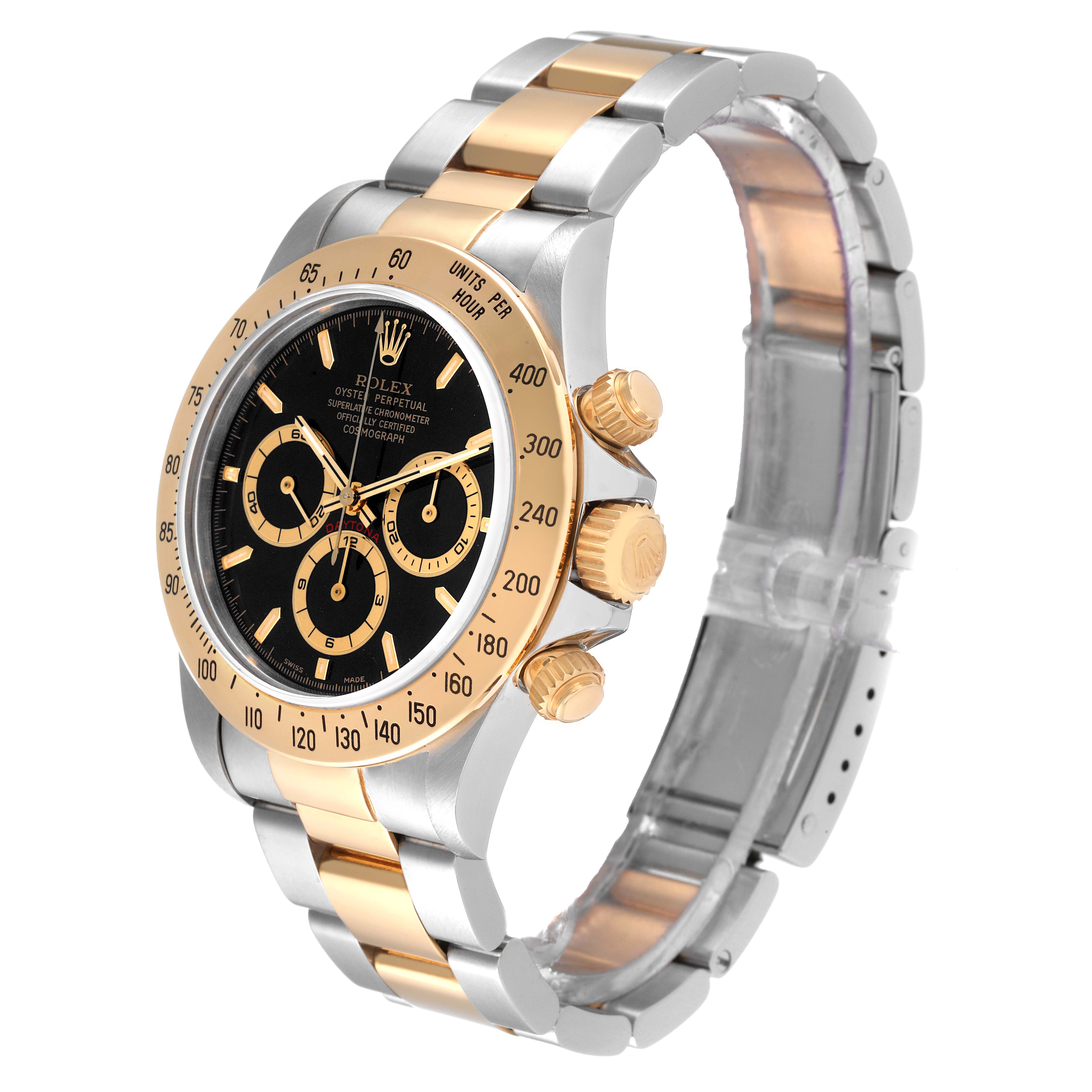 The image shows a stainless steel and gold Rolex Daytona 16523 Men's Steel and Gold (two tone) Black Dial 16523 Men's Steel and Gold (two tone) Black Dial watch at a three-quarter angle, highlighting the face and bracelet.