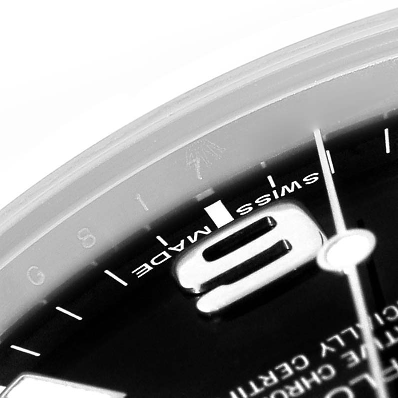 The close-up image shows the dial of a Rolex Explorer 214270 Men
s Stainless Steel Black Dial 214270 Men
s Stainless Steel Black Dial watch, highlighting part of the "9" numeral and the "Swiss Made" text.