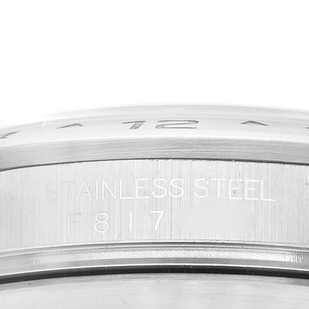 This image shows a close-up view of the stainless steel bezel and engraved case side of the Rolex Explorer 16570 Men's Stainless Steel White Dial 16570 Men's Stainless Steel White Dial watch.