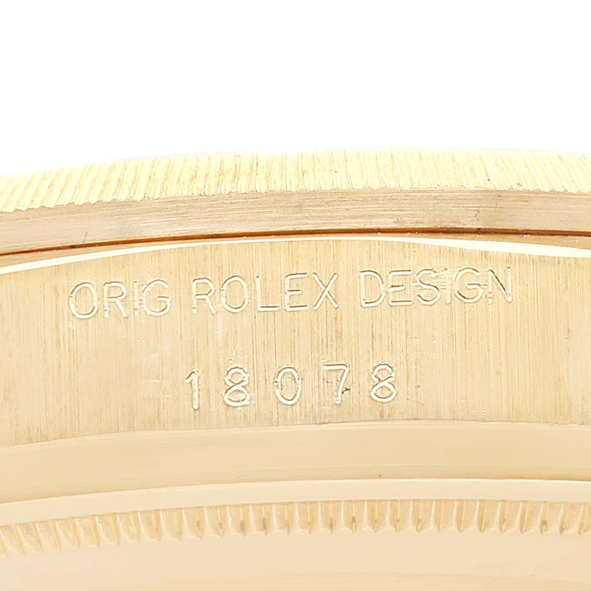 This close-up image shows the side of the Rolex President 18078 Men
s Yellow Gold Champagne Dial 18078 Men
s Yellow Gold Champagne Dial model watch, highlighting its model number and "Rolex Design" engraving.