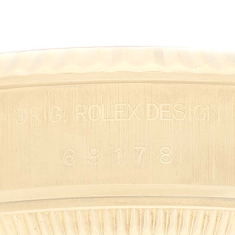 This image shows a close-up of the engravings on the side of a Rolex President 69178 Women's Yellow Gold Champagne Dial 69178 Women's Yellow Gold Champagne Dial model watch.