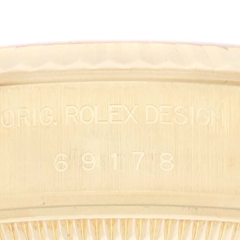 This image shows a close-up of the case with engravings on a Rolex President 69178 Women
s Yellow Gold Champagne Dial 69178 Women
s Yellow Gold Champagne Dial model watch.