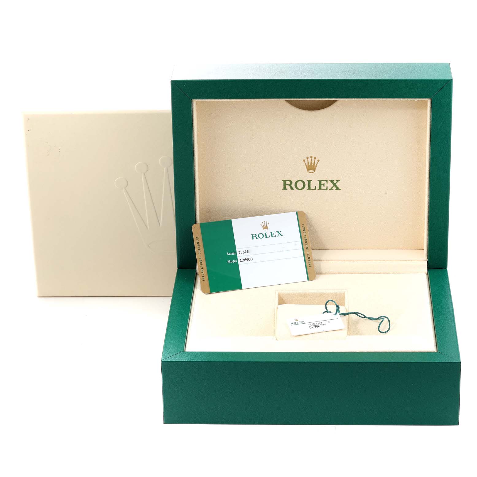 The image shows an open green Rolex box for the Sea-Dweller model, displaying a warranty card and a tag inside.