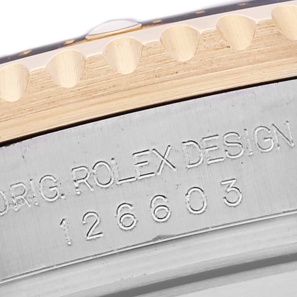 The image shows a close-up of the case edge and serial number engraving on a Rolex Sea-Dweller 126603 Men's Stainless Steel Black Dial 126603 Men's Stainless Steel Black Dial watch.