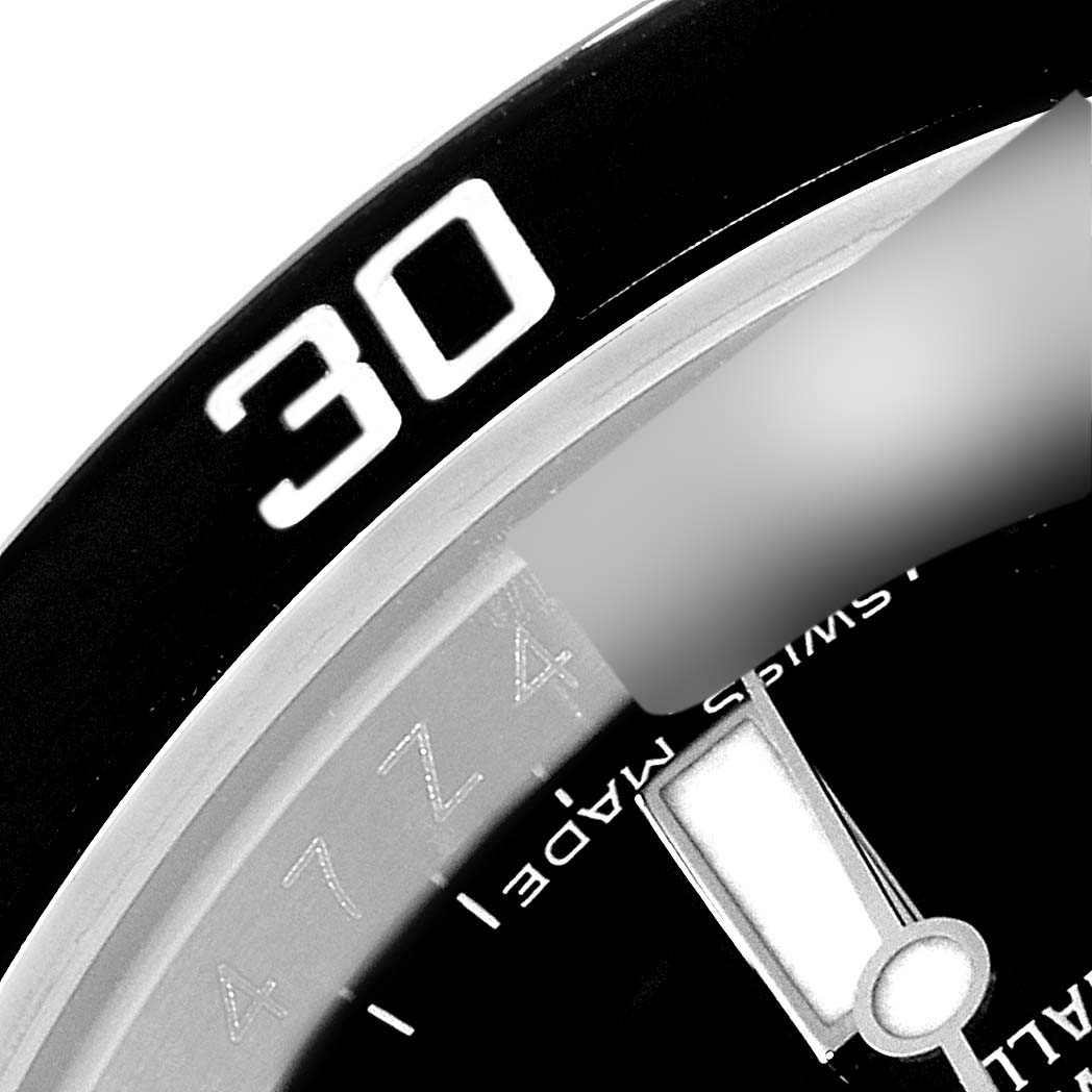This image shows a close-up of the bezel and part of the dial of the Rolex Submariner 116610 Men
s Stainless Steel Black Dial 116610 Men
s Stainless Steel Black Dial watch, focusing on the 30-minute mark.