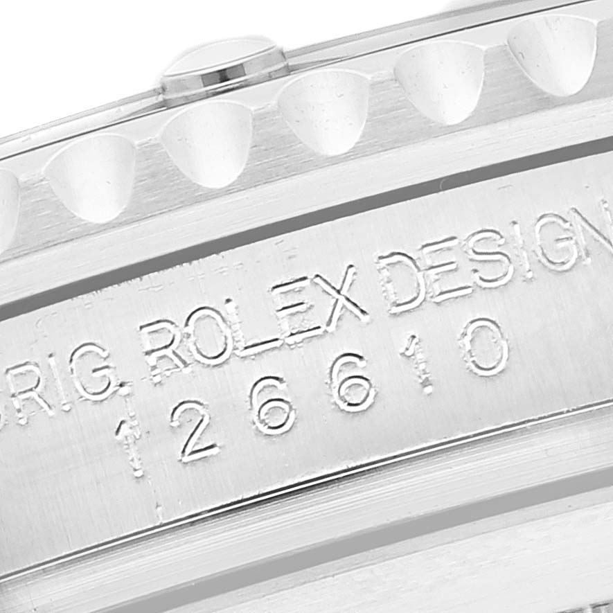 This close-up image of a Rolex Submariner 126610 Men
s Stainless Steel Black Dial 126610 Men
s Stainless Steel Black Dial watch shows a partial view of the case with engraved model number 126610 and "ROLEX DESIGN."