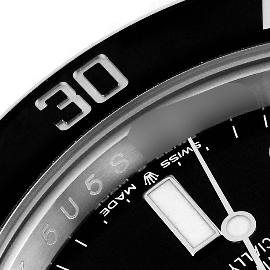 The image shows a close-up of a Rolex Submariner 126610 Men
s Stainless Steel Black Dial 126610 Men
s Stainless Steel Black Dial watch bezel and part of the dial at an angled view.