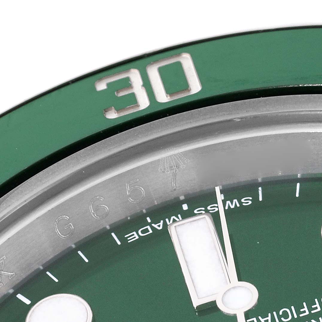 The image shows a close-up of the green bezel and part of the dial of a Rolex Submariner 116610LV Men's Stainless Steel Green Dial 116610LV Men's Stainless Steel Green Dial watch.