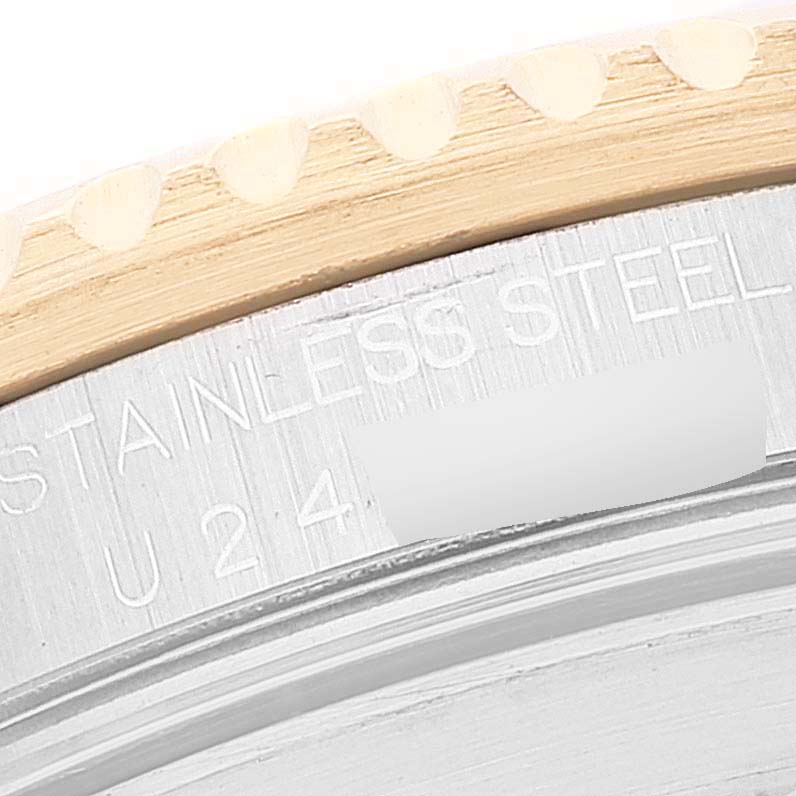 This image shows a close-up of the case back and bezel edge of a Rolex Submariner 16613 Men
s Steel and Gold (two tone) Champagne Dial 16613 Men
s Steel and Gold (two tone) Champagne Dial watch, highlighting the engraving.