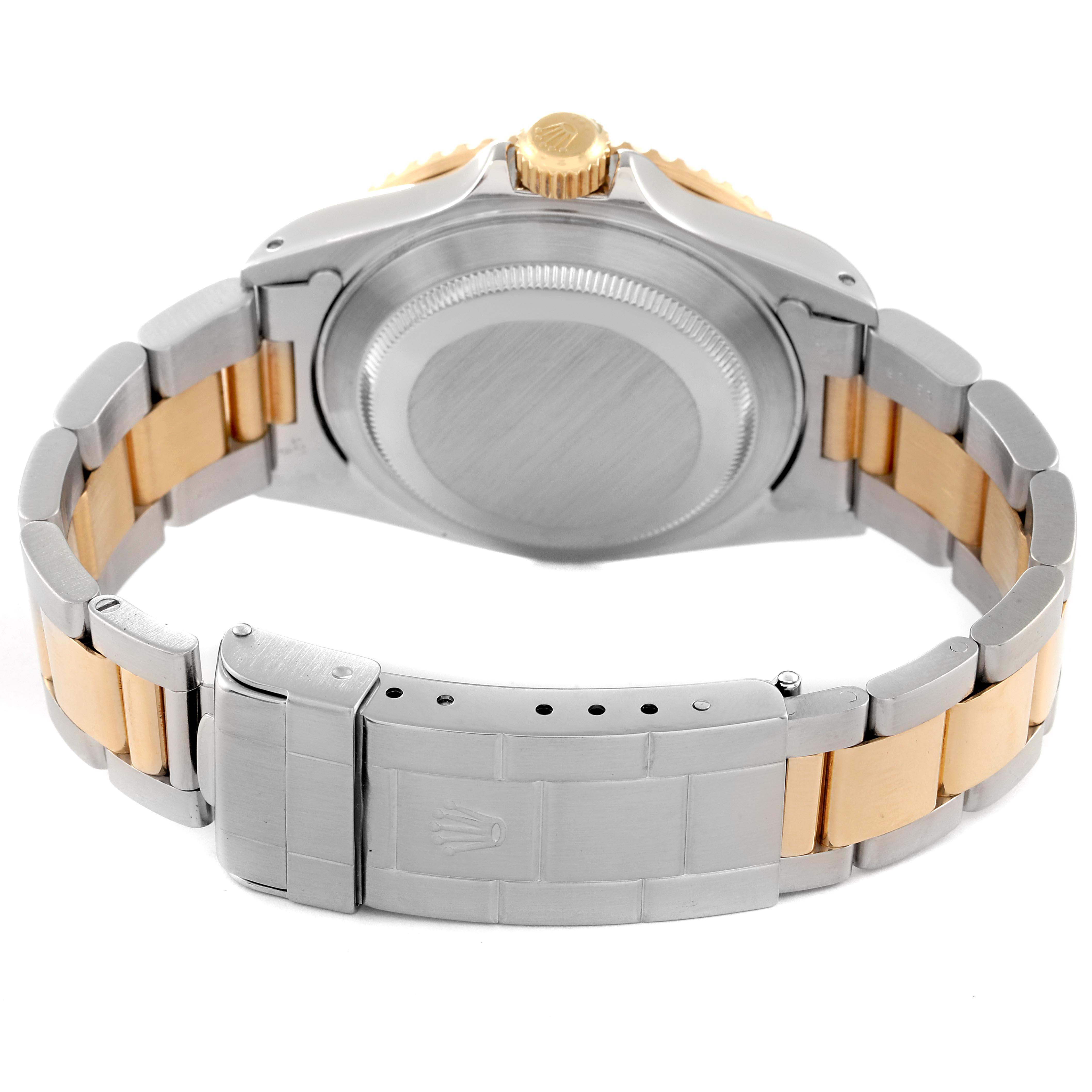 The image shows the back view of a Rolex Submariner 16613 Men
s Steel and Gold (two tone) Champagne Dial 16613 Men
s Steel and Gold (two tone) Champagne Dial watch, highlighting its case back and two-tone bracelet with clasp.