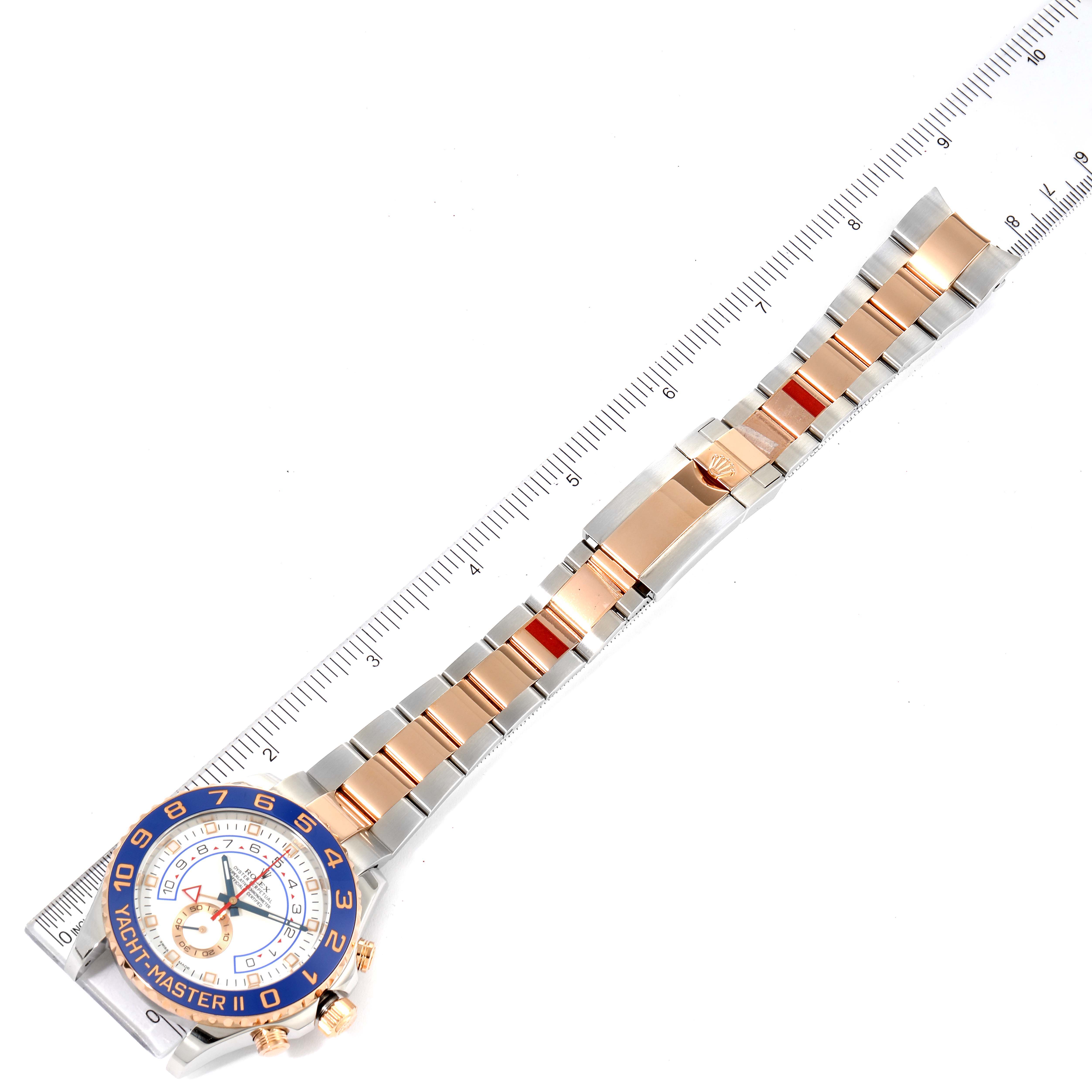 The Rolex Yacht-Master 116681 Men's Steel and Gold (two tone) White Dial 116681 Men's Steel and Gold (two tone) White Dial watch is shown from the top, highlighting its face, bezel, and bracelet against a ruler for scale.