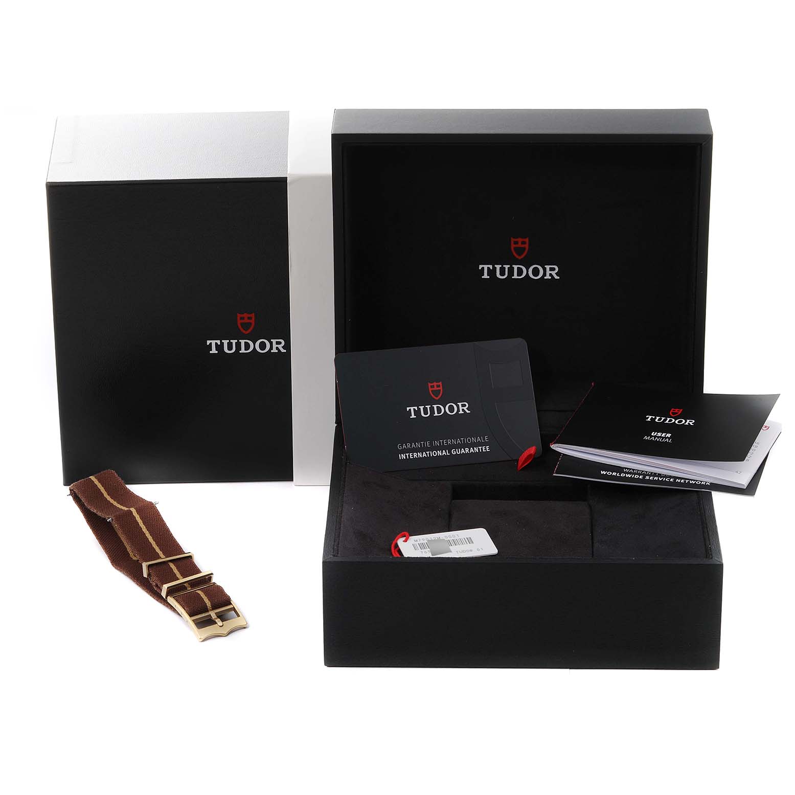 The image shows Tudor Heritage Black Bay 79012 Men's Bronze Brown Dial 79012 Men's Bronze Brown Dial packaging, manuals, a tag, and an extra watch strap from an angled view.