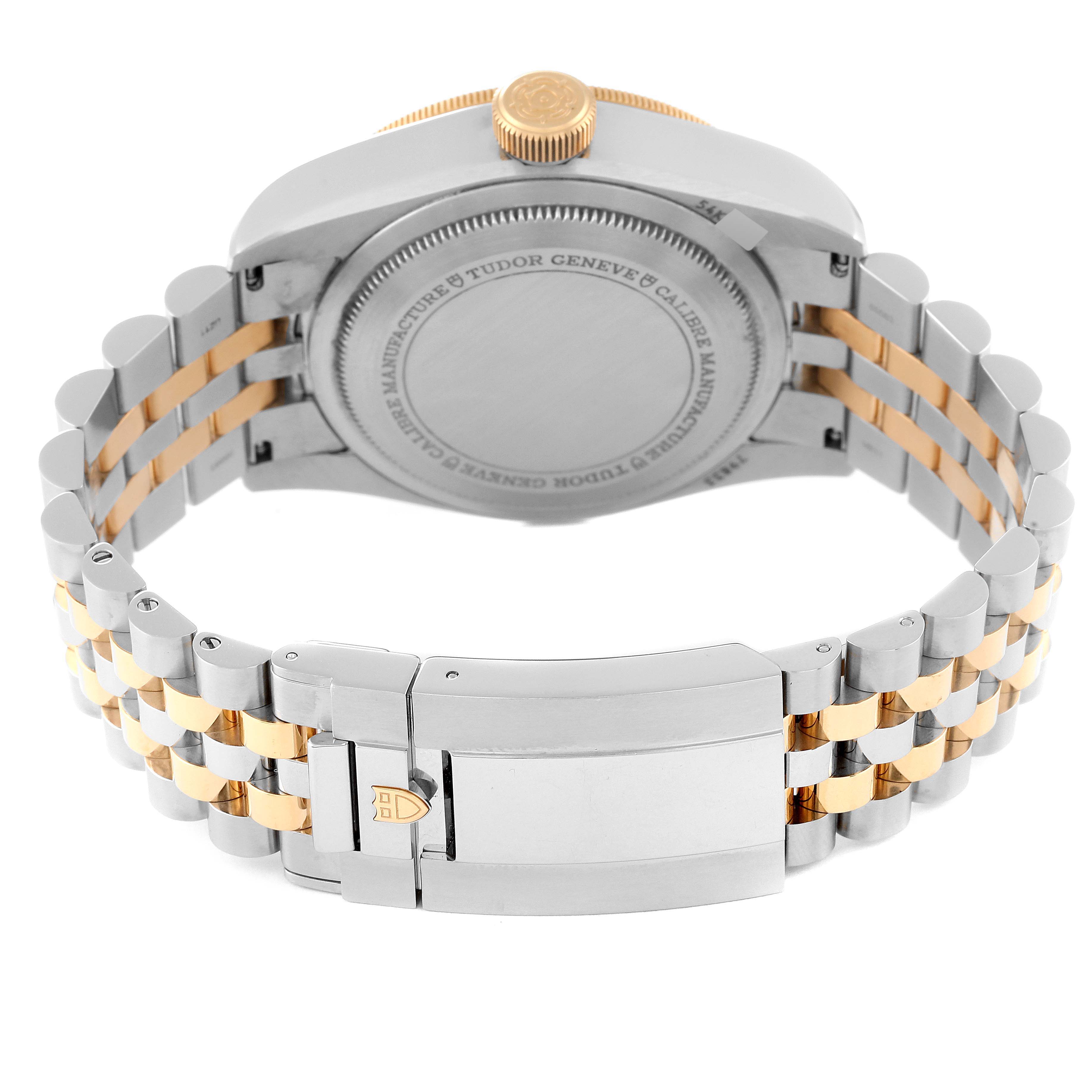 The image shows the back view of the Tudor Heritage Black Bay 79833MN Men
s Stainless Steel Black Dial 79833MN Men
s Stainless Steel Black Dial watch, highlighting the case back and bi-tone bracelet.