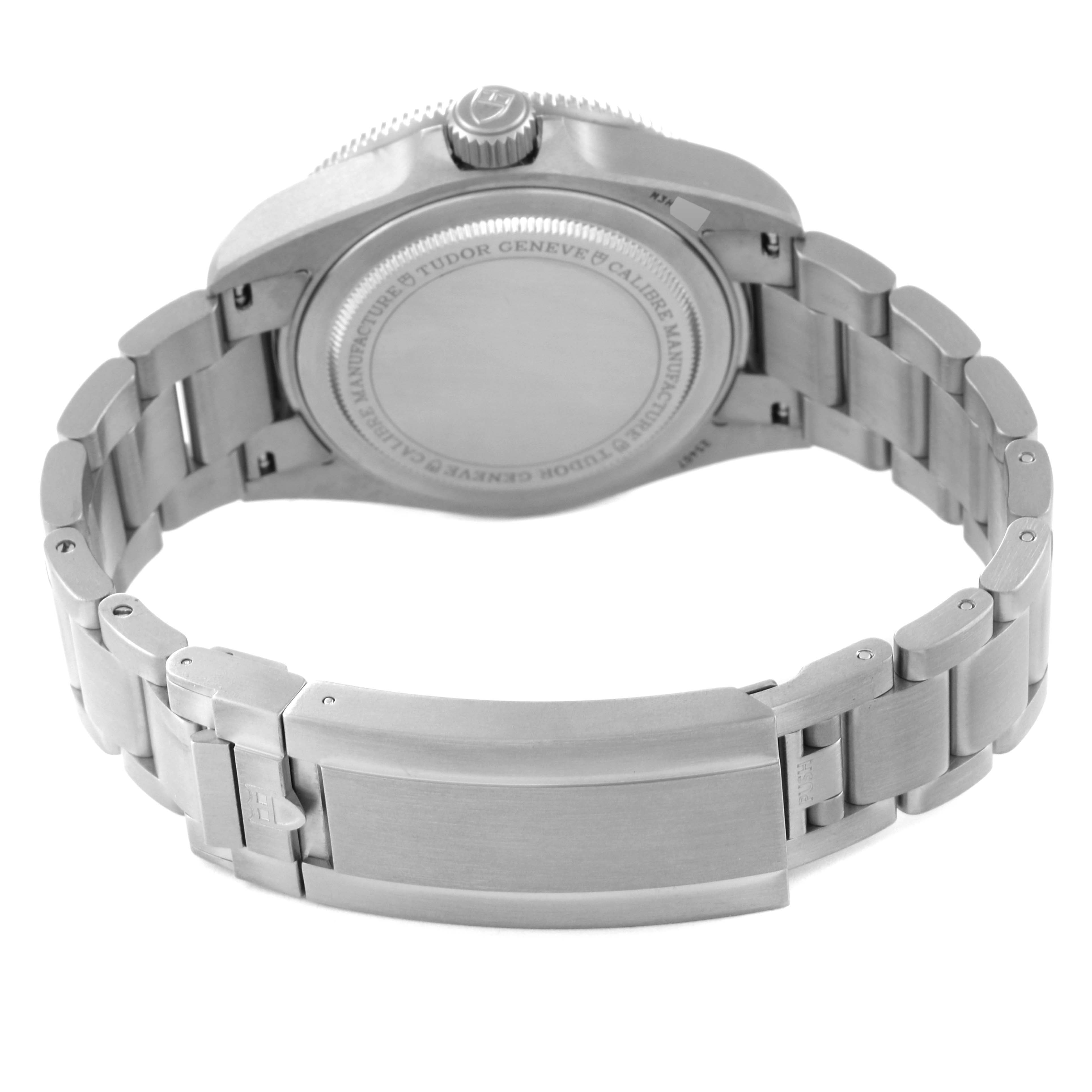 This image shows the backside and clasp of a Tudor Pelagos 25407N Men
s Titanium Black Dial 25407N Men
s Titanium Black Dial watch, highlighting its metal bracelet and caseback.