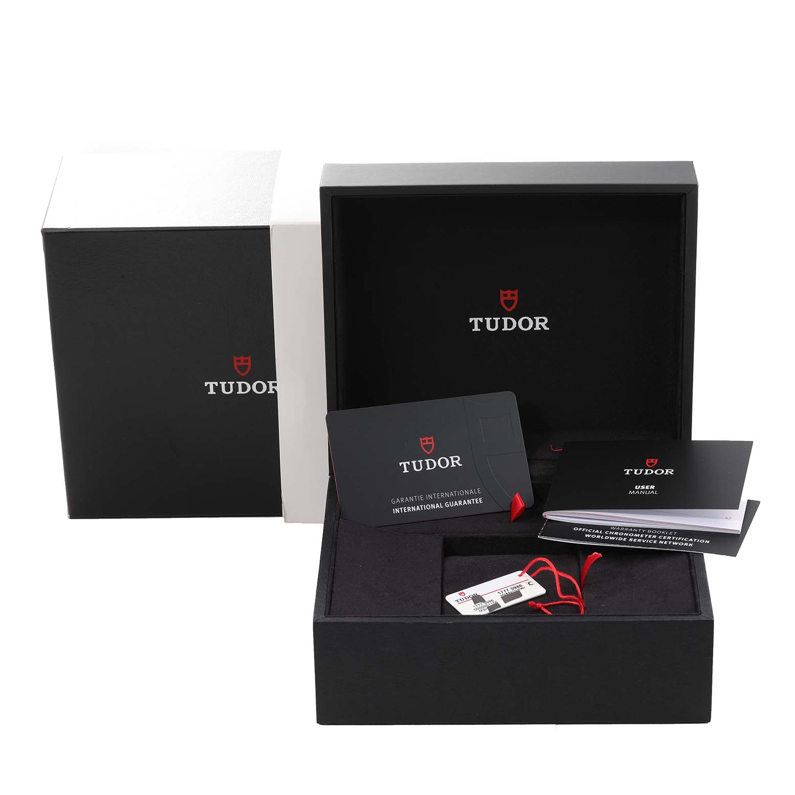 The Tudor Pelagos 25407N Men
s Titanium Black Dial 25407N Men
s Titanium Black Dial watch accessories include warranty cards, a user manual, and tags in an open presentation box.