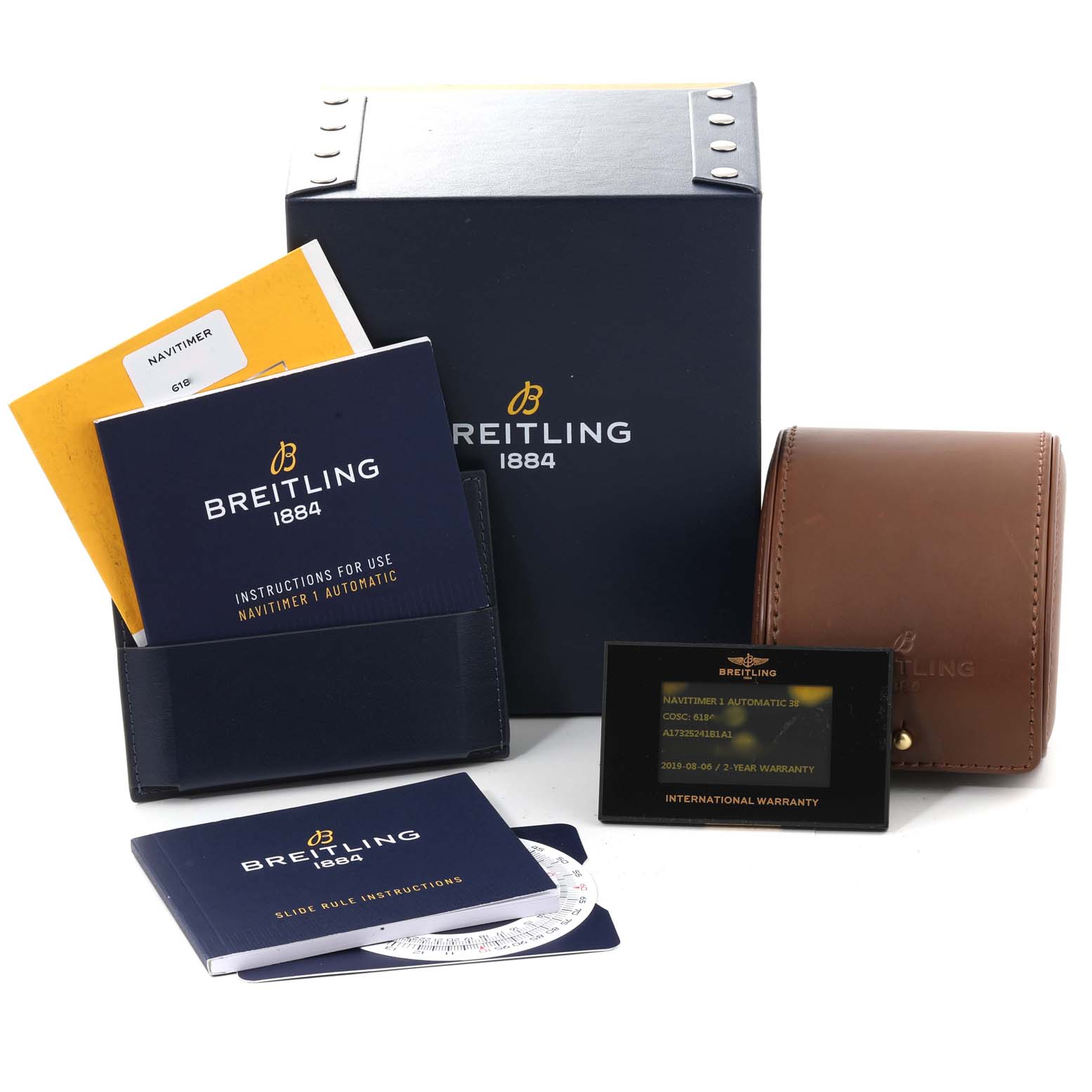 The image shows accessories for the Breitling Navitimer A17325 Men's Stainless Steel Black Dial A17325 Men's Stainless Steel Black Dial model, including boxes, manuals, a warranty card, and a leather case.