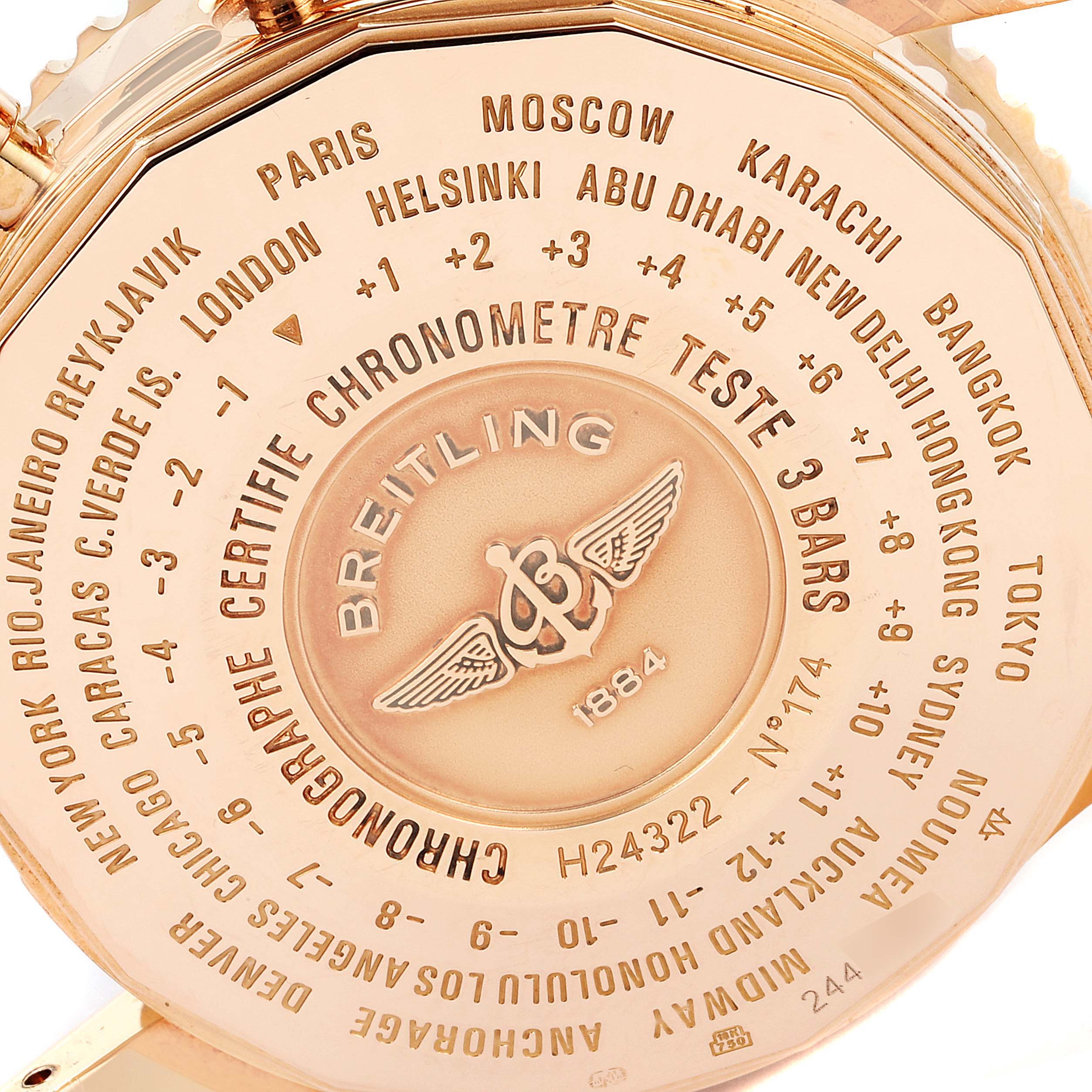 The image shows the back case of a Breitling Navitimer H24322 Men
s Rose Gold Black Dial H24322 Men
s Rose Gold Black Dial watch, displaying various time zones and chronometer certification details.