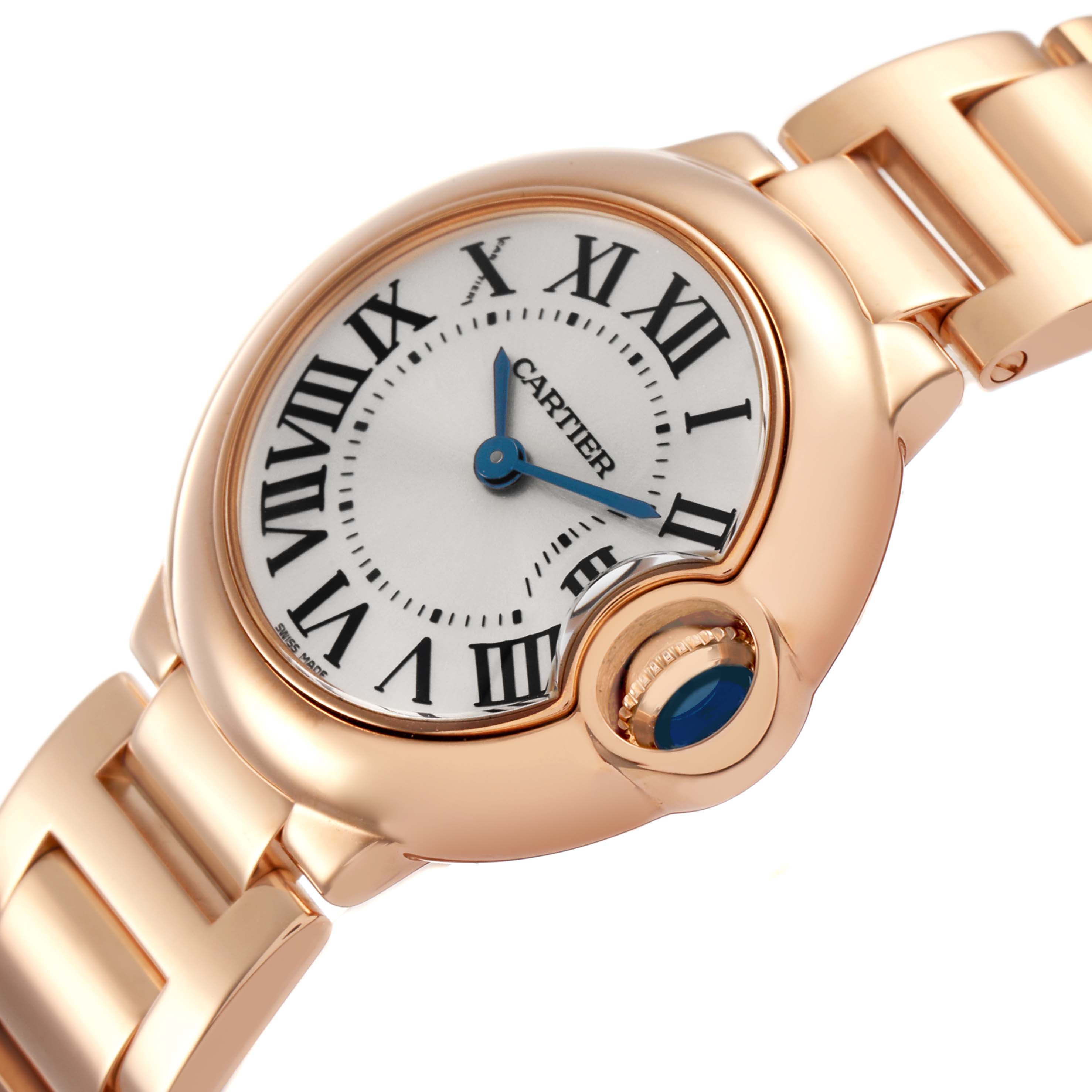 The image shows the Cartier Ballon Bleu W69002Z2 Women's Rose Gold Silver Dial watch at an angled side view, highlighting the gold case, blue sapphire cabochon crown, and bracelet.