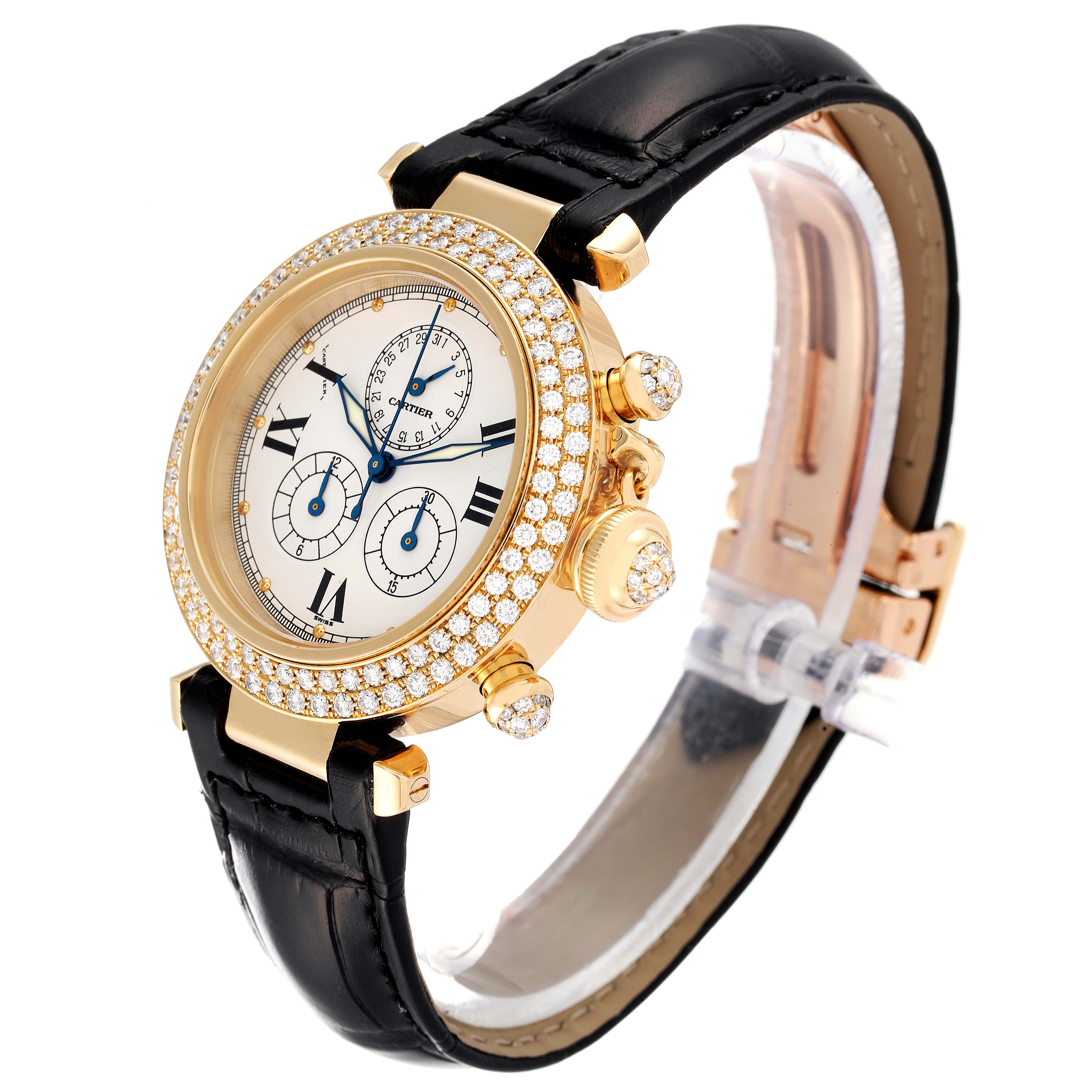 The Cartier Pasha 1354 Men's Yellow Gold Silver Dial 1354 Men's Yellow Gold Silver Dial watch is shown from a three-quarter angle, highlighting its gold case, diamond bezel, black leather strap, and chronograph dials.