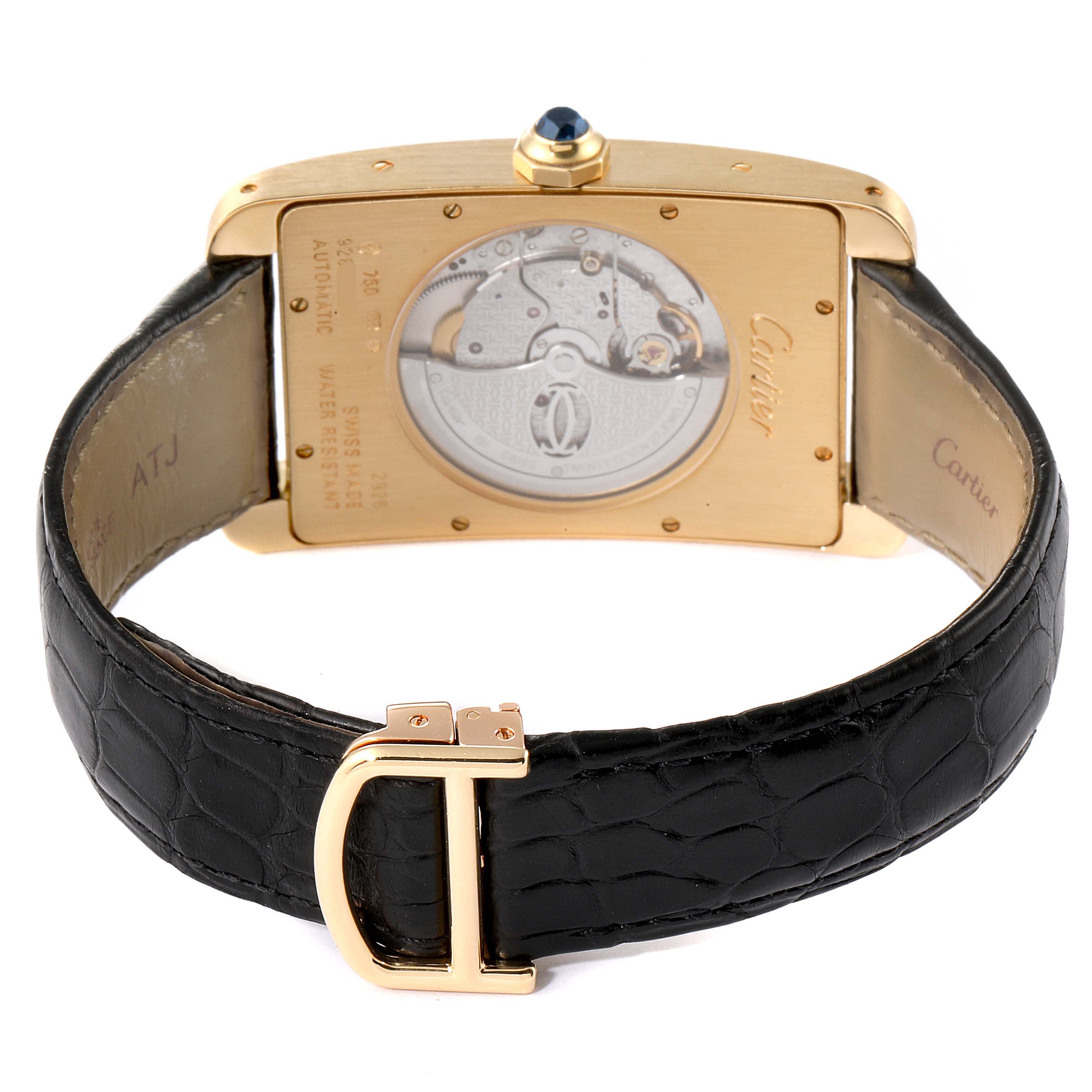 The Cartier Tank Américaine watch is shown from the back, displaying its movement and gold clasp.