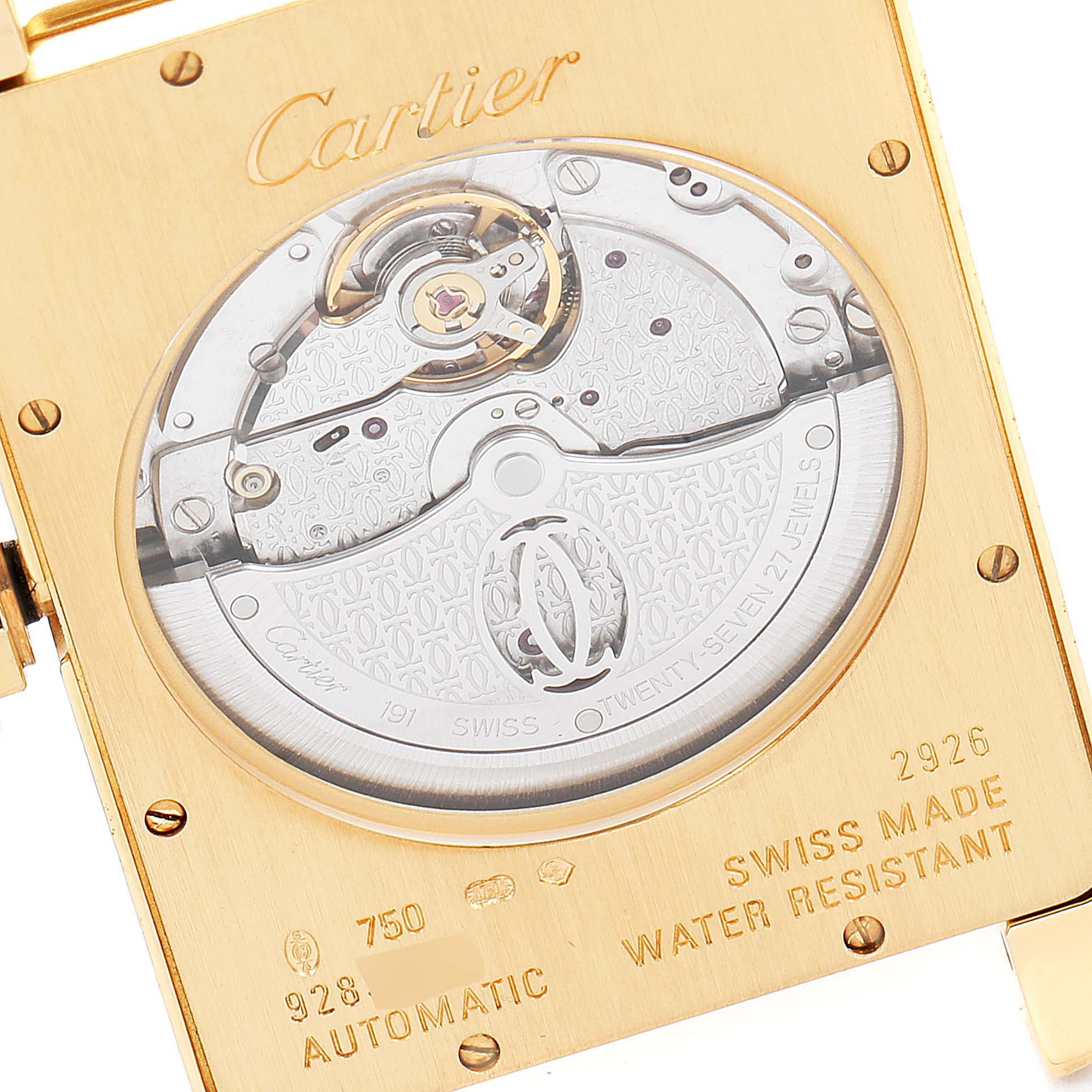 The image shows the back of a Cartier Tank Americaine W2609756 Men's Yellow Gold Silver Dial W2609756 Men's Yellow Gold Silver Dial watch, highlighting its automatic movement and inscriptions.