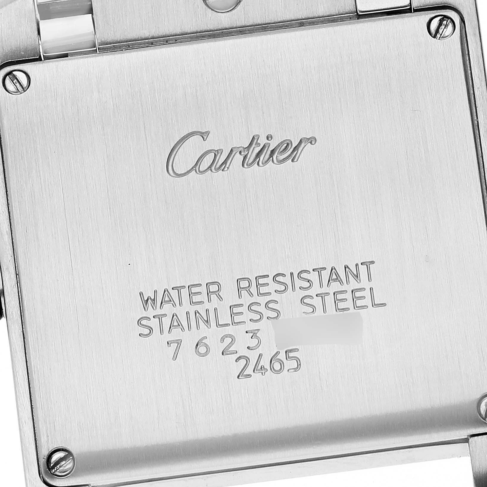 The image shows the back case of a Tank Française watch by Cartier, engraved with details about its water resistance and material.