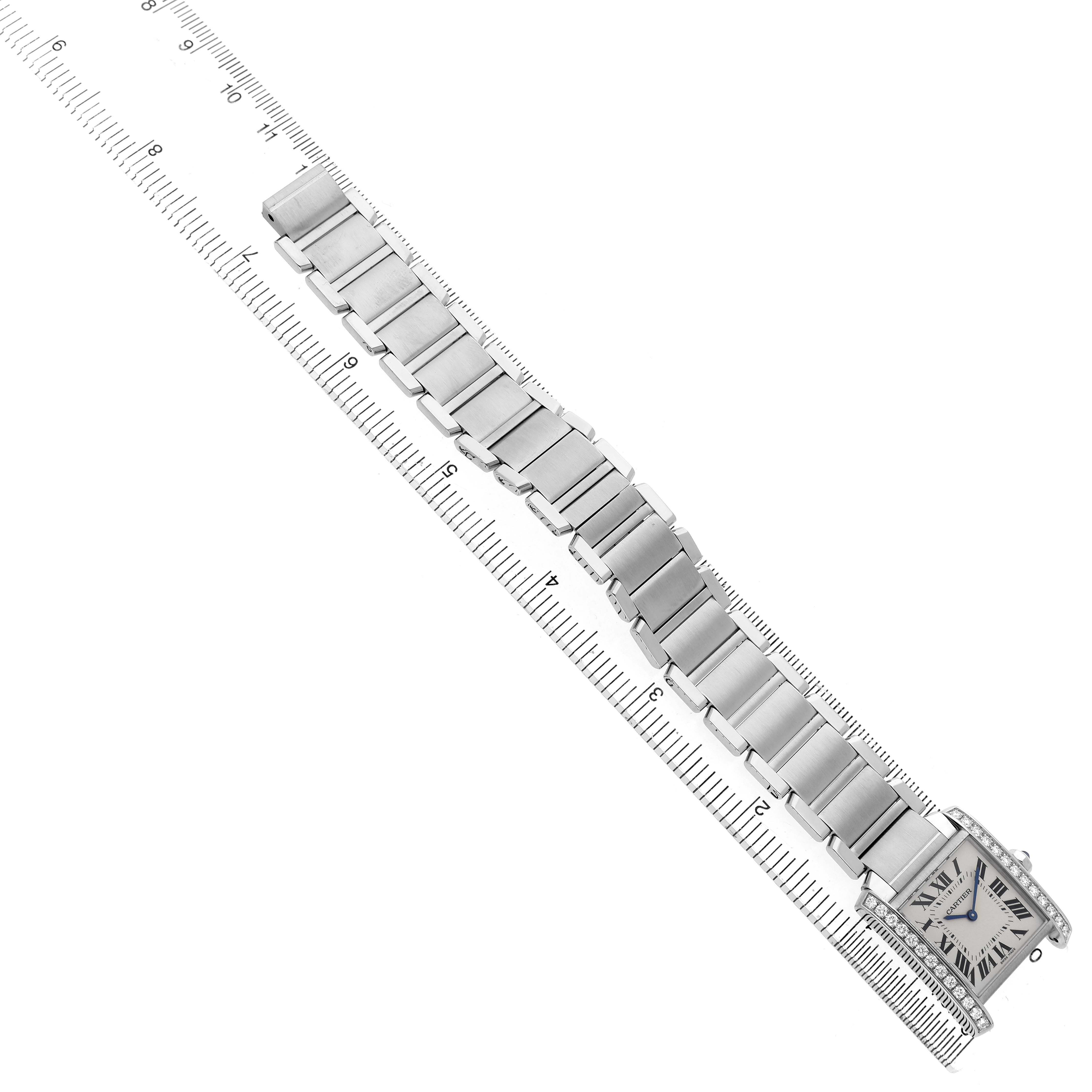 The Cartier Tank Française watch is displayed flat from a top view, showing the entire bracelet and face.